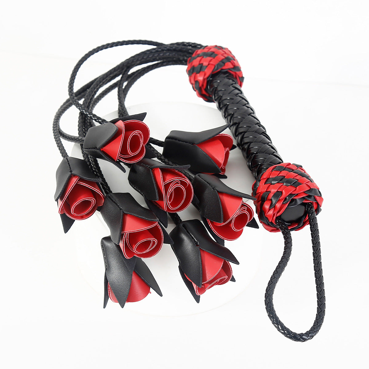Flogger, whip and leather with roses