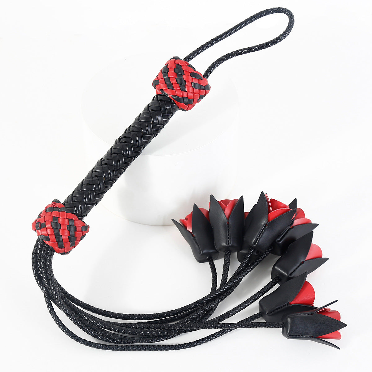 Flogger, whip and leather with roses