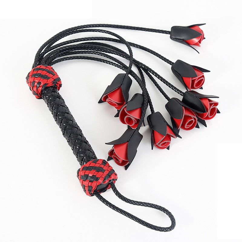 Flogger, whip and leather with roses