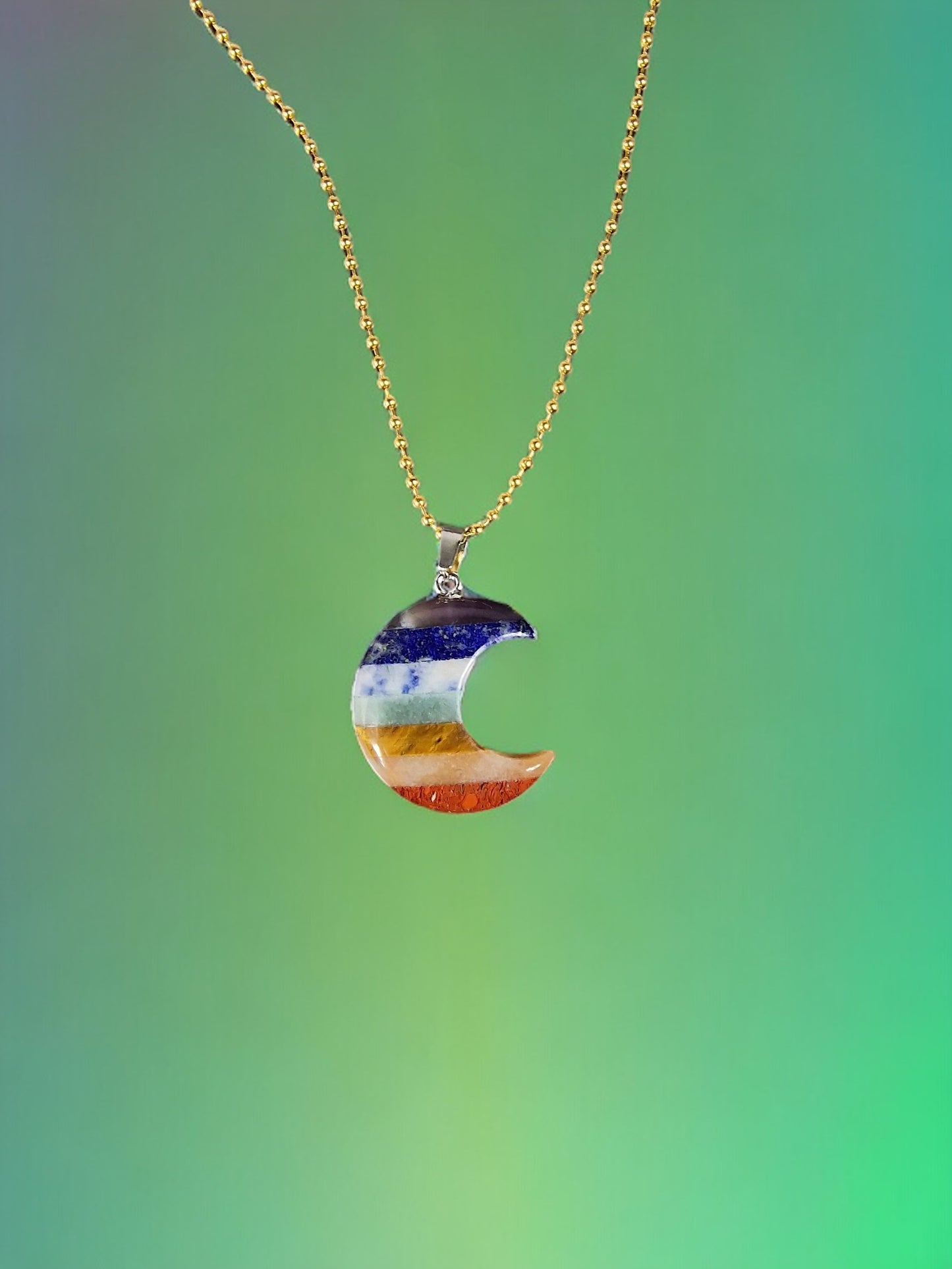 Rainbow colored necklace, seven chakras necklace in the shape of a crescent in various crystals and stones