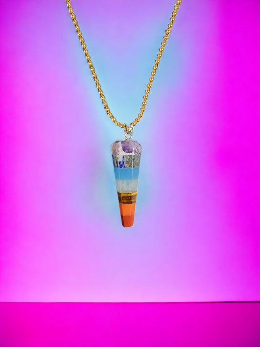 Rainbow colored necklace with seven chakras pendant, shaped like a narrow scepter