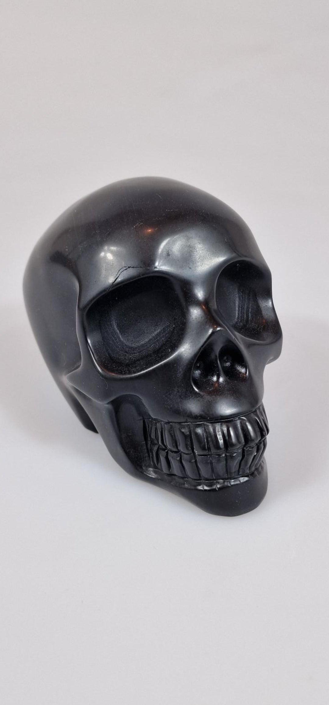 Schwarzer Onyx-Kristallschädel. Totenkopf aus schwarzem Onyx-Edelstein.