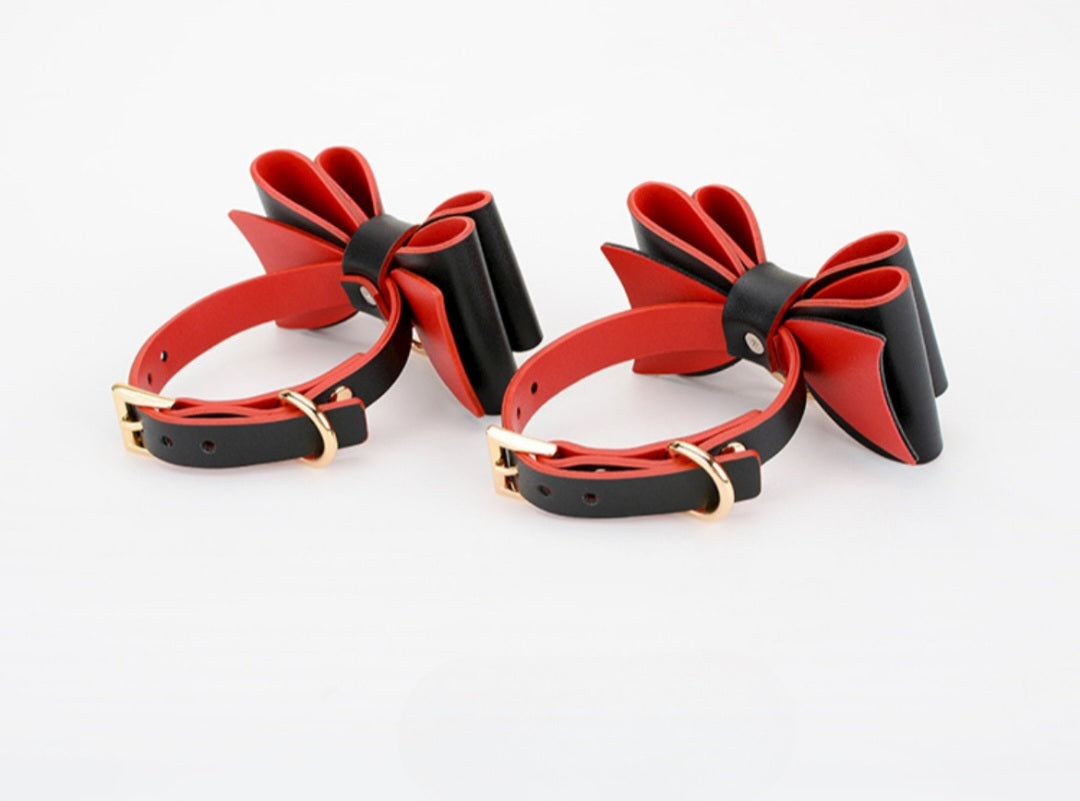 Bold and stylish black or red-black leather cuffs with bow for hands or feet