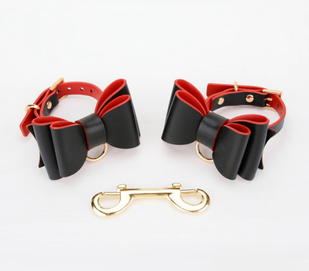 Bold and stylish black or red-black leather cuffs with bow for hands or feet