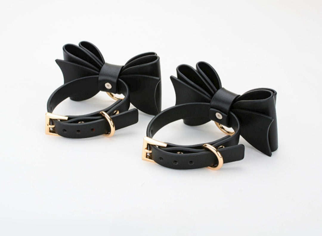 Bold and stylish black or red-black leather cuffs with bow for hands or feet