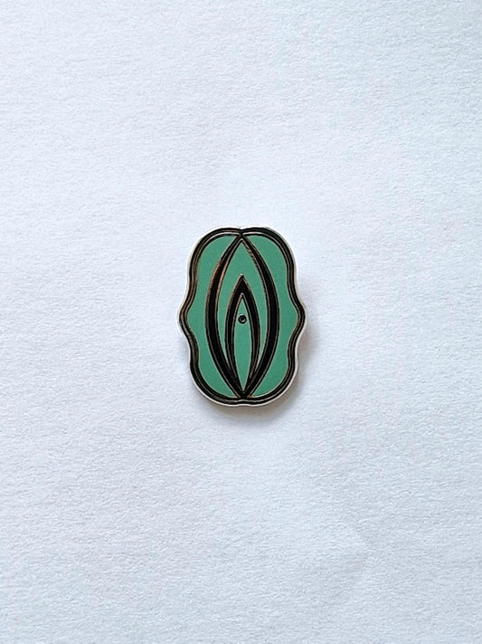 Funny and personal pin in the form of a green and black bow or snipe.