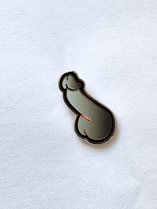 Cock-shaped and funny pin in the form of a silver and black dick.