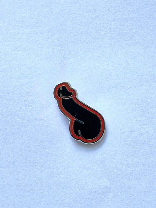 Funny and different pin, black and orange dick.