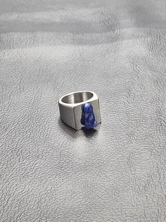 Silver colored ring with the blue crystal or semi-precious stone Sodalite