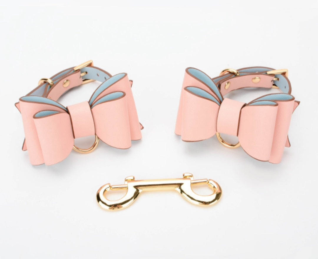 Bold and stylish pink leather cuffs with bow for hands or feet