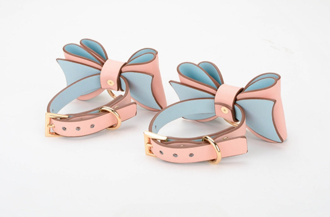 Bold and stylish pink leather cuffs with bow for hands or feet