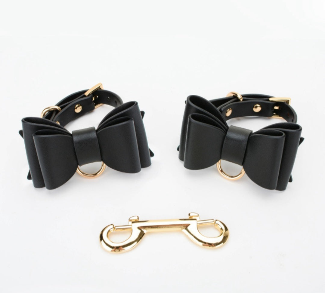 Bold and stylish black or red-black leather cuffs with bow for hands or feet