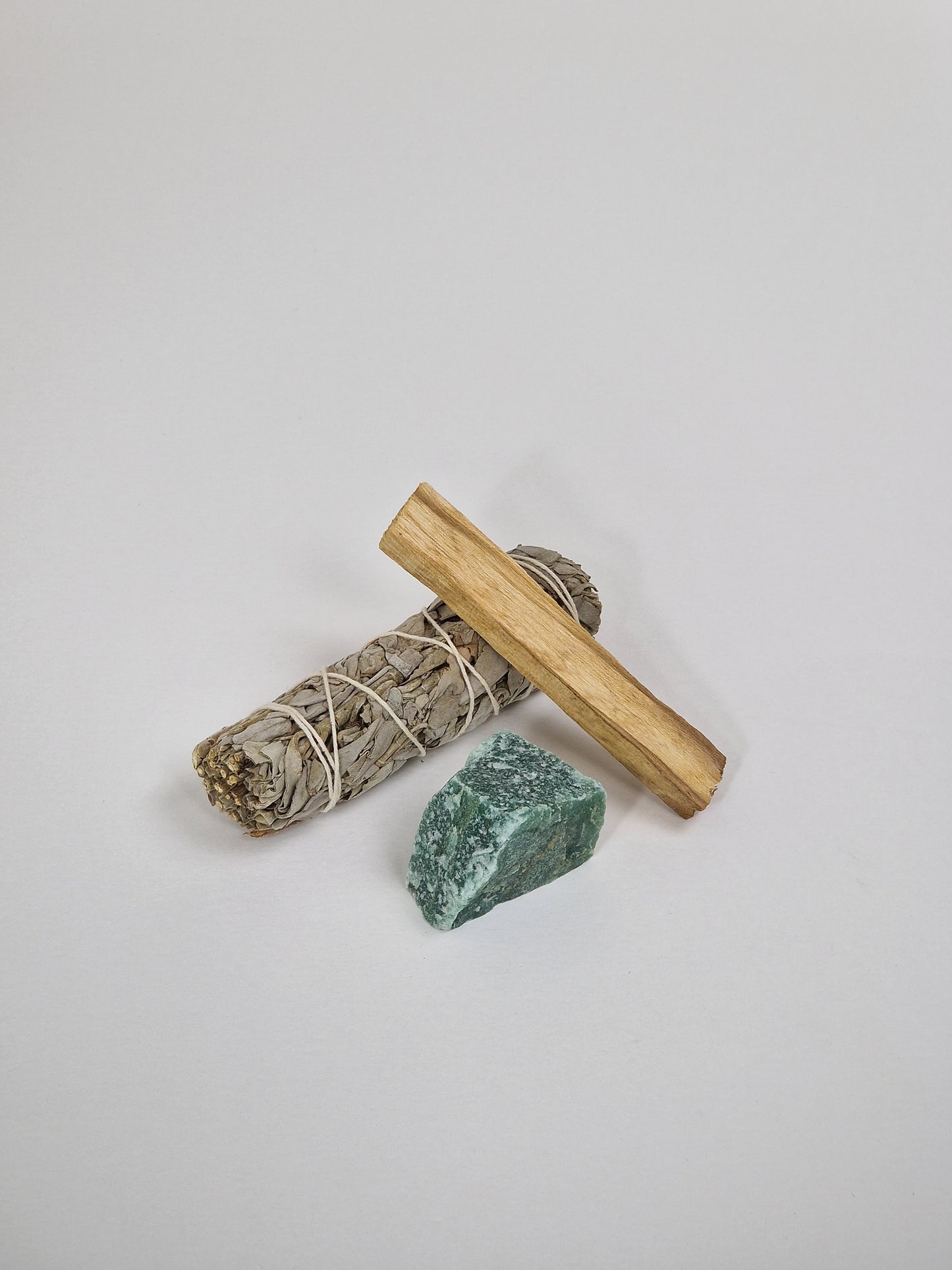 Green Aventurine crystal with sage and smudge stick